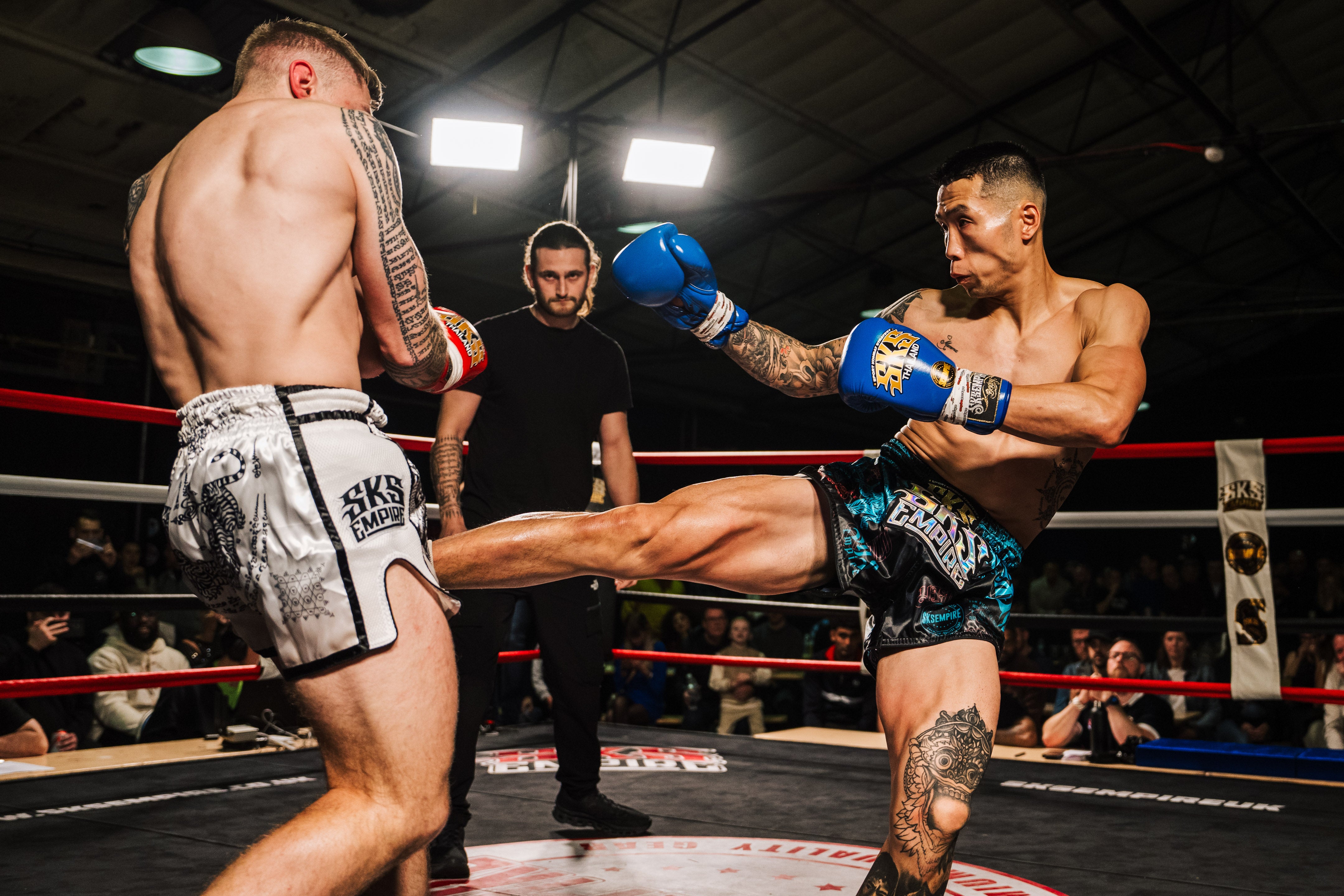 Two Muay Thai fighters kicking