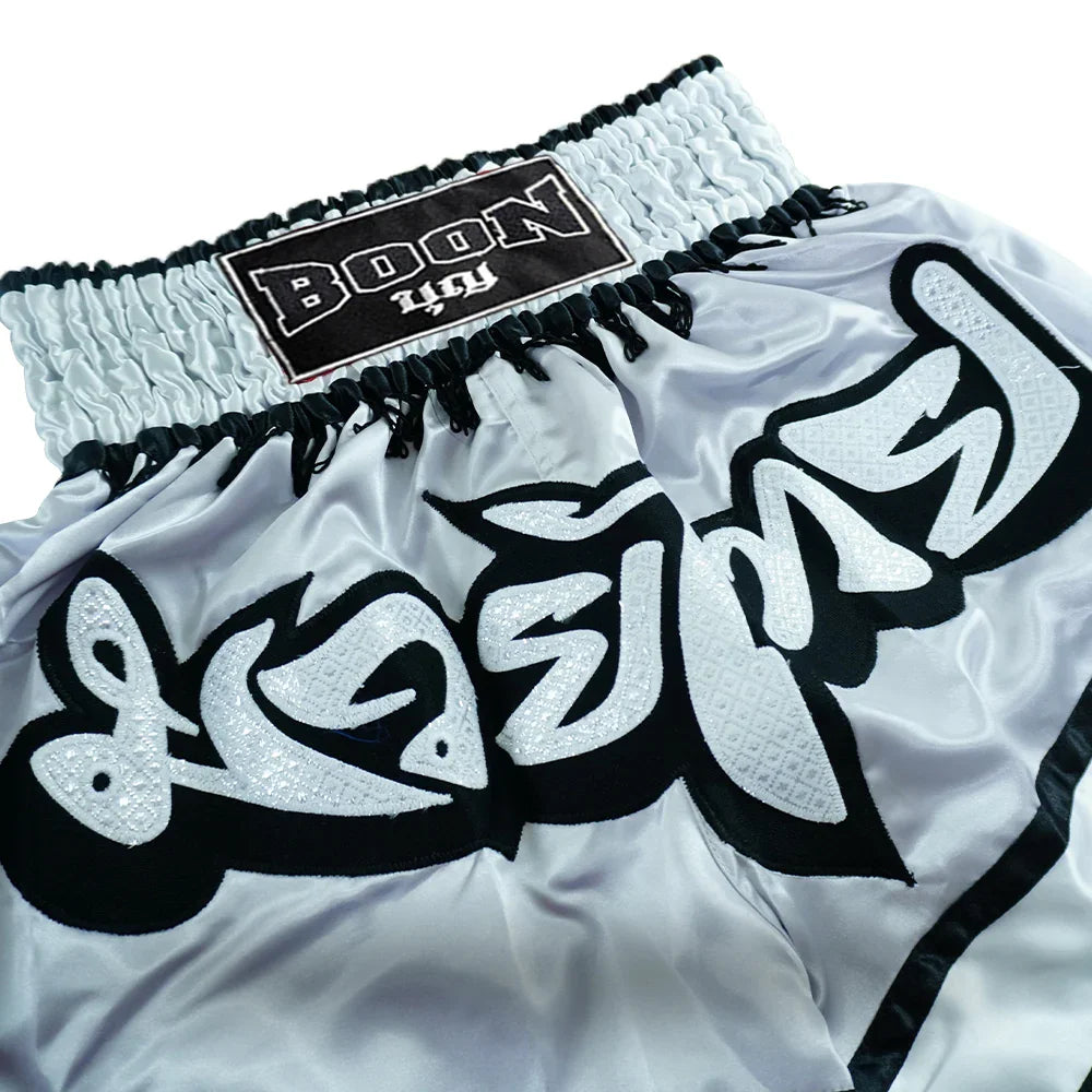 Close-up of Boon grey Muay Thai shorts with detailed embroidery and branded waistband