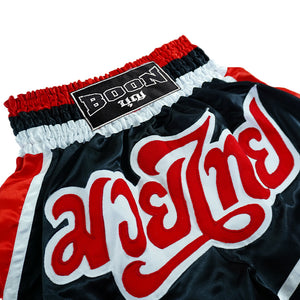Boon traditional Muay Thai shorts in black, red, and white with bold embroidered text.