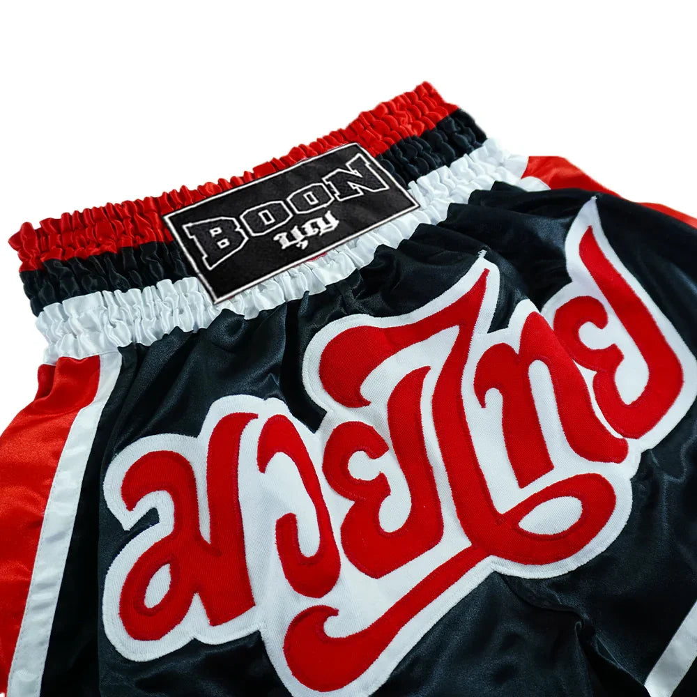 Boon traditional Muay Thai shorts in black, red, and white with bold embroidered text.