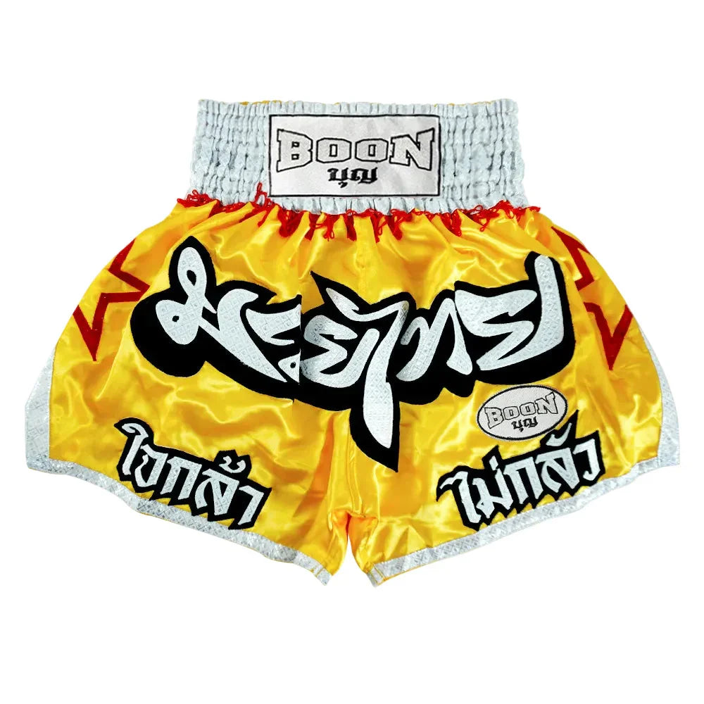 Boon yellow Muay Thai shorts with Thai script, red stars, and silver trim, Muay Thailand gear