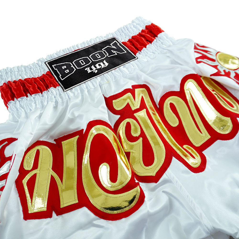 Boon traditional Muay Thai shorts in white with gold and red Thai script, Muay Thailand gear