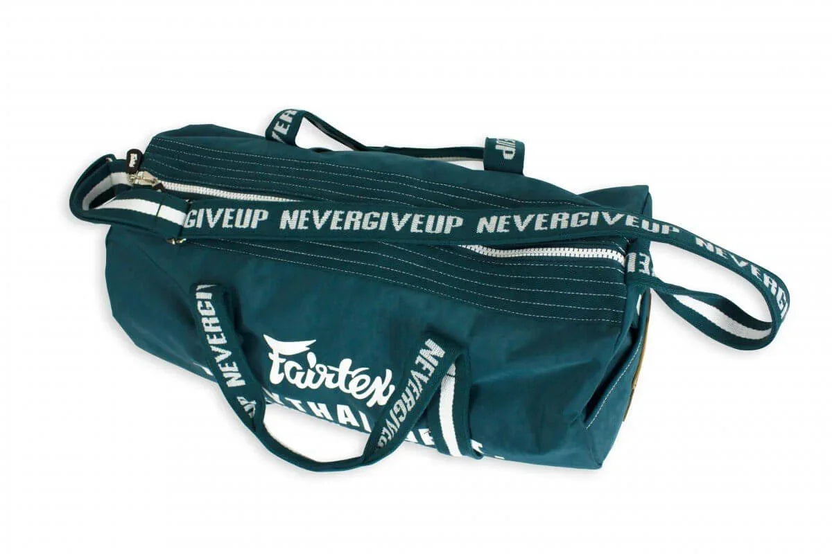Fairtex barrel gym bag with NEVERGIVEUP strap, teal, Muay Thai training gear