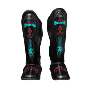 Black SKS Empire Muay Thai microfiber shin pads with blue and red tiger bomb design