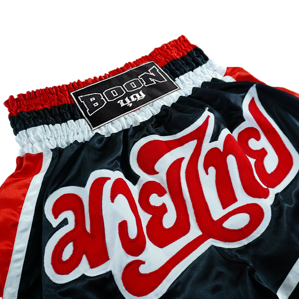 Boon traditional Muay Thai shorts in black, red, and white with bold embroidered text.