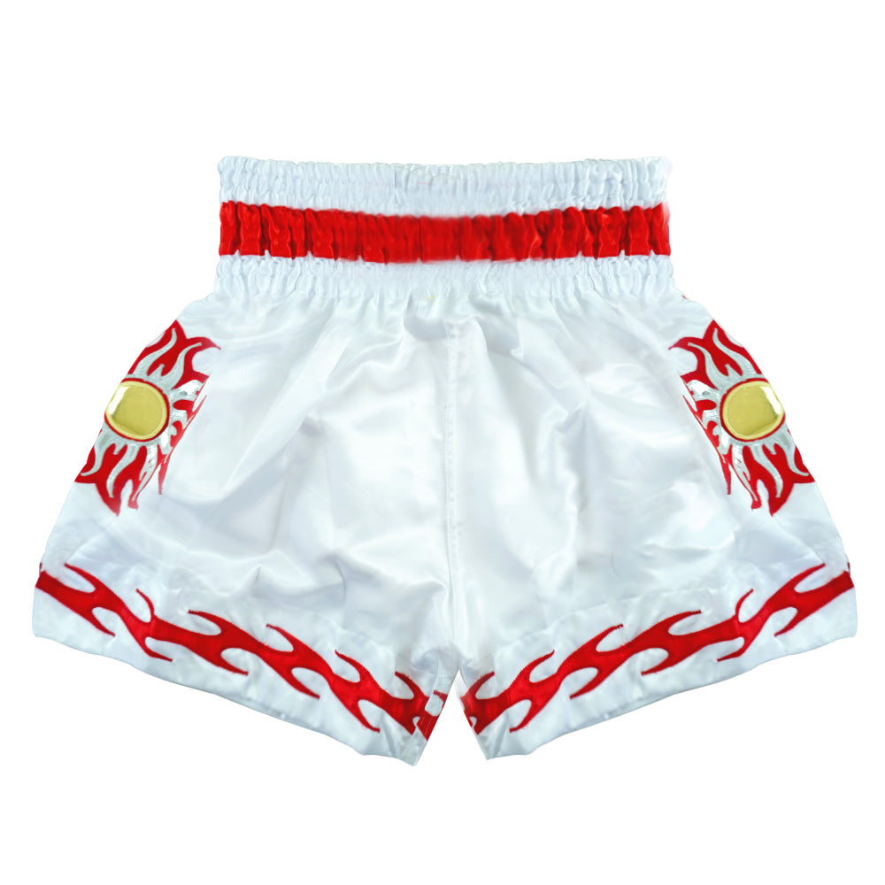 White Muay Thai shorts with red flames and gold sun patch, elastic red waistband