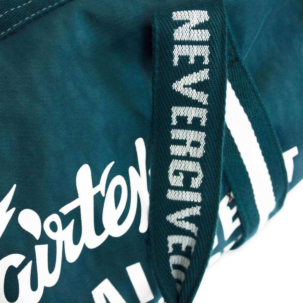 Fairtex Muay Thai barrel bag with 'Never Give Up' strap and visible branding