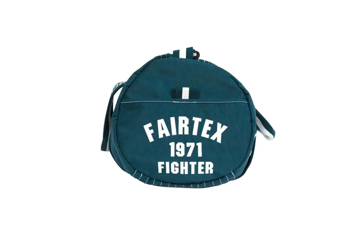 Fairtex 1971 Fighter round barrel gym bag with shoulder strap on white background