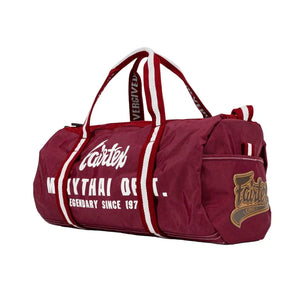 Fairtex burgundy Muay Thai gym barrel bag with white logo and red striped handles