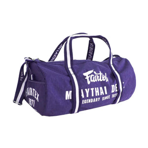Fairtex purple Muay Thai barrel bag with white logo and text, gym sports duffel