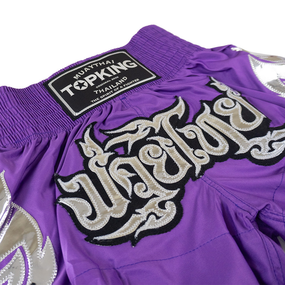 Top King Muay Thai shorts in purple with embroidered silver Thai script, Muay Thailand gear